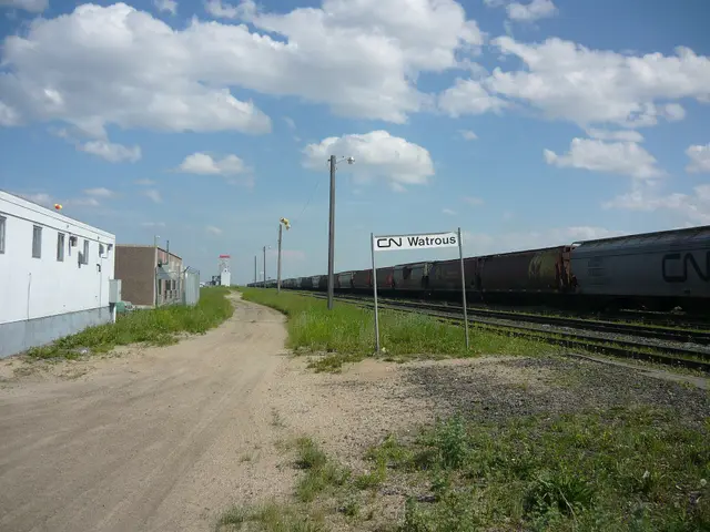 CN Watrous sign and grain cars on the tracks